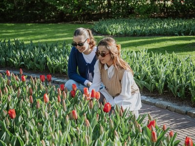 Keukenhof girls admiring red tulips